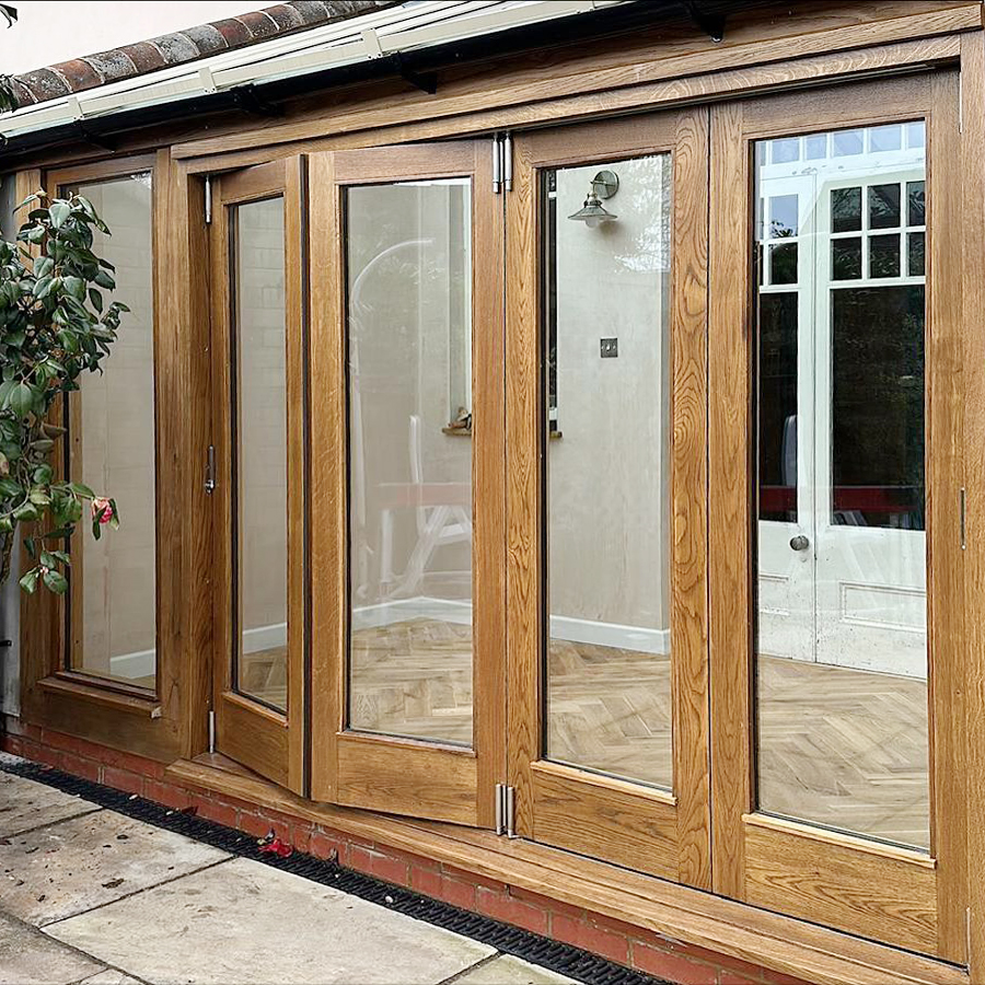 Solid oak bifold doors opening onto the garden